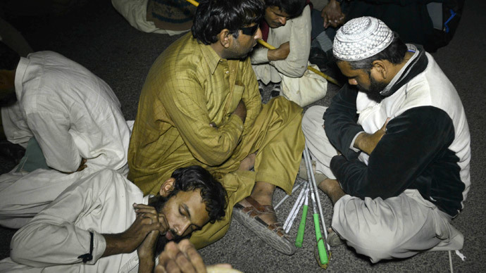 Pakistani blind youth sit on the street during a protest for jobs in Lahore on December 3, 2014.(AFP Photo / Arif Ali)