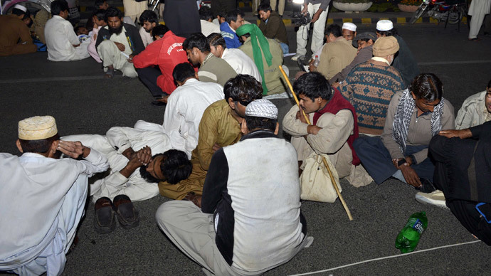 Pakistani blind youth sit on the street during a protest for jobs in Lahore on December 3, 2014.(AFP Photo / Arif Ali)