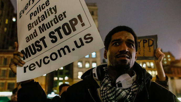 A man holds a banner as he takes part during a protest in support of Eric Garner at Union Square on December 3, 2014 in New York City.(AFP Photo / Kena Betancur)