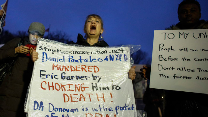 A woman holds a banner as she takes part during a protest in support of Eric Garner at Union Square on December 3, 2014 in New York City. (AFP Photo / Kena Betancur)