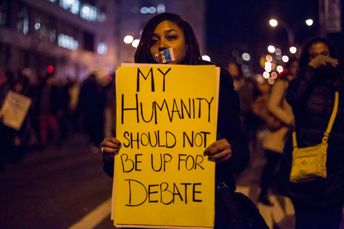 A female protester, demanding justice for Eric Garner, holds a placard in Brooklyn, New York December 4, 2014. (Reuters / Elizabeth Shafiroff)