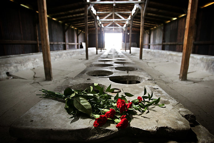 Flowers are placed inside one of the barracks of the Auschwitz-Birkenau death camp in Oswiecim. (Reuters/Damir Sagolj)
