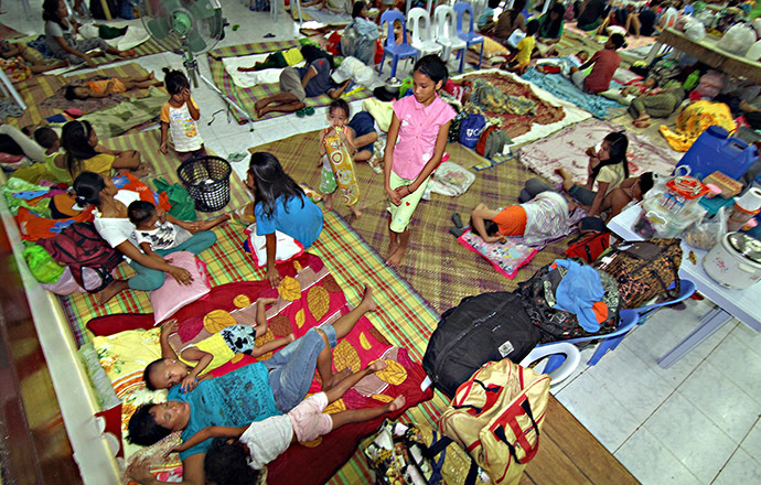 Residents rest inside an evacuation center in Surigao City, in southern island of Mindanao on December 5, 2014, ahead of the landfall of Typhoon Hagupit. (AFP Photo)