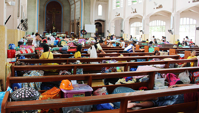 People take shelter inside a church after evacuating their homes due to super-typhoon Hagupit in Tacloban city, central Philippines December 5, 2014. (Reuters/Rowel Montes)