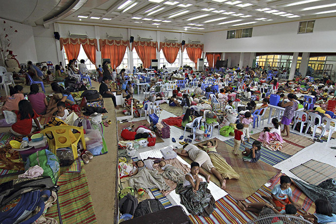 People take shelter inside a evacuation centre after evacuating from their homes due to super-typhoon Hagupit in Surigao city, southern Philippines December 5, 2014. (Reuters/Stringer)