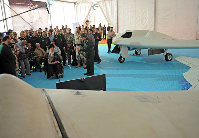 A handout picture released by the office of Iran's Supreme Leader Ayatollah Ali Khamenei on May 11, 2014 shows him (C-L) sitting next to the captured US RQ-170 sentinel high-altitude reconnaissance that crashed in Iran. (AFP Photo/Iranian Leader's Website)
