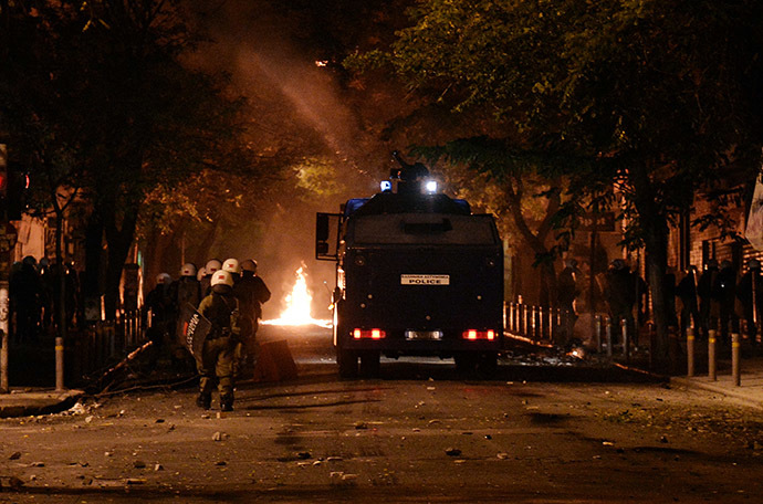 Greek police take position during clashes with protesters commemorating the six-year anniversary of the fatal shooting of teenager Alexis Grigoropoulos by a police officer, an event that plunged Greece into weeks of youth riots, in Athens on December 6, 2014. (AFP Photo/Louisa Gouliamaki)