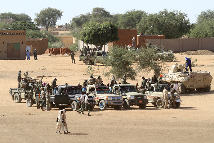A picture taken during a government organised tour shows Sudanese troops standing guard in the village of Tabit, in the North Darfur (AFP Photo)