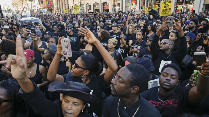 Demonstrators block traffic in front of the TCL Chinese Theatre, as they protest against police violence, including the July chokehold death of unarmed black man Eric Garner in New York, near the area where LAPD shot an assault suspect on December 5, in Hollywood, California December 6, 2014. (Reuters/Patrick T. Fallon)