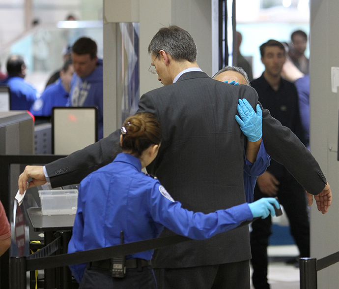 An air traveler is patted down after passing through a full-body scanner at Los Angeles International Airport (LAX) (AFP Photo / David McNew)