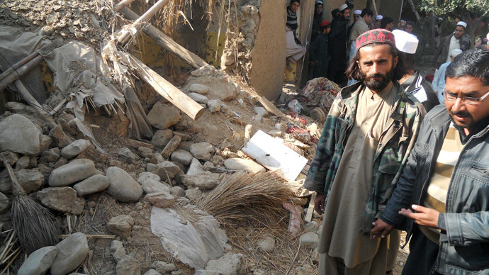 Pakistani Islamic students gather at a destroyed religious seminary belonging to the Haqqani network after US drone strike in the Hangu district of Khyber Pakhtunkhwa province on November 21, 2013.(AFP Photo / SB Shah)