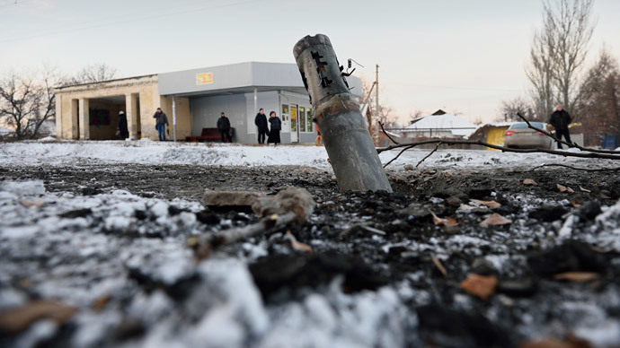 People wait at a tramway stop near a shell that felt nearby in the district of Kirovskiy in the eastern Ukrainian city of Donetsk.(AFP Photo / Eric Feferberg)