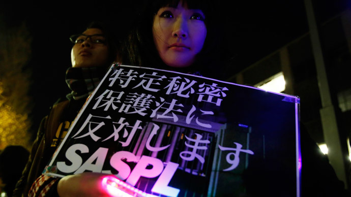 A protester holding a placard demonstrates against a state-secrets law during a rally in Tokyo December 9, 2014.(Reuters / Yuya Shino)