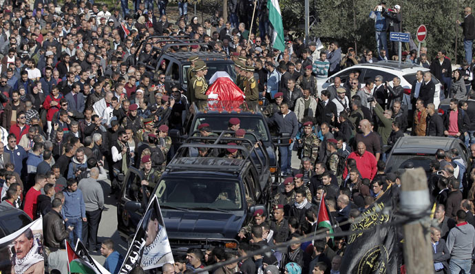 Palestinian security members drive with the coffin of senior Palestinian official Ziad Abu Ein during his funeral in the West Bank city of Ramallah on December 11, 2014. (AFP Photo/Ahmad Gharabli)