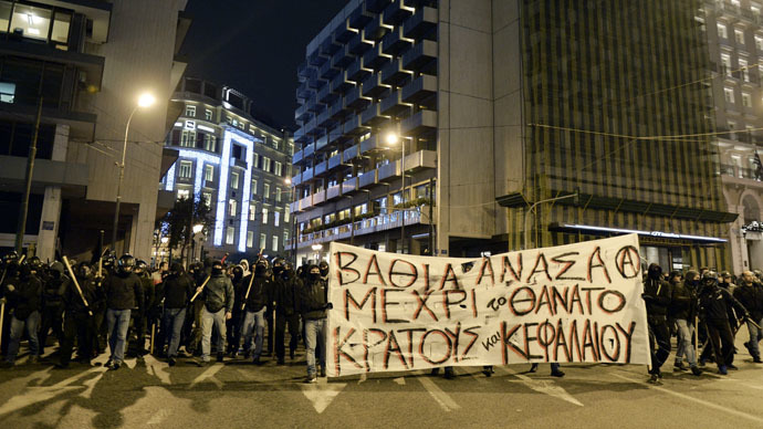 Protesters carry a banner reading "Deep breath until the death of the state and the capital" in central Athens on December 2, 2014 during a massive march in solidarity with a 22-years old anarchist hunger striker, Nikos Romanos. (AFP Photo)