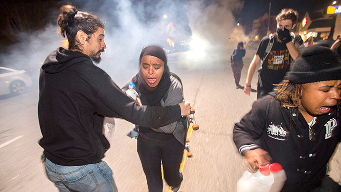 Protesters retreat while police officers deploy teargas to disperse a crowd comprised largely of student protesters during a protest against police violence in the U.S., in Berkeley, California December 7, 2014 (Reuters / Noah Berger)