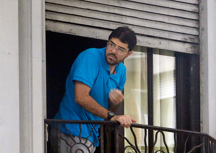 Syrian Omar Mahmoud Faraj stands on the balcony of a house he shares with five other former Guatanamo detainees, in a neighbourhood in Montevideo December 12, 2014 (Reuters / Andres Stapff)