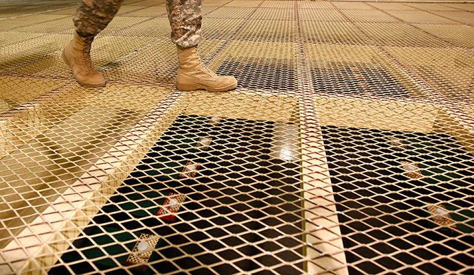 A U.S. soldier walks above prison cells at a new detention centre at the U.S. Bagram Air Base, north of Kabul (Reuters / Jonathon Burch)