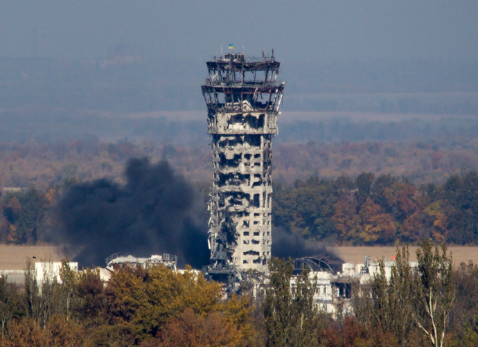 A Ukrainian national flag flies at top of a badly damaged traffic control tower as smoke rises after shelling at the Donetsk Sergey Prokofiev International Airport in Donetsk, eastern Ukraine.(Reuters / Shamil Zhumatov)