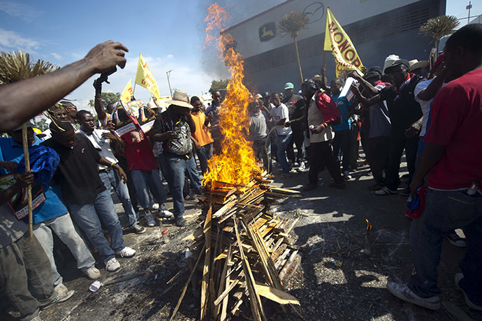Demonstrators perform a voodoo ceremony prior to a protest against the government of President Michel Martelly in Port-au-Prince, on December 13, 2014. (AFP Photo/Hector Retamal)
