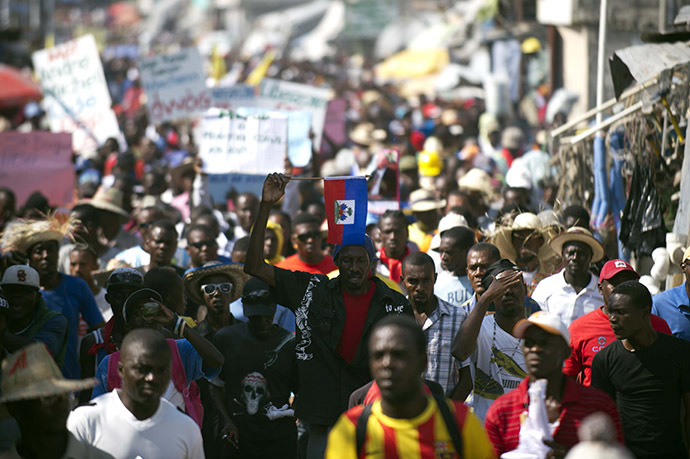 Demonstrators march during a protest against the government of President Michel Martelly in Port-au-Prince, on December 13, 2014. (AFP Photo/Hector Retamal)