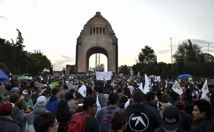 People protest demanding justice and clarification of the disappearance of 43 students from Ayotzinapa, on December 6, 2014 at the revolution monument in Mexico City. (AFP Photo/Yuri Cortez)