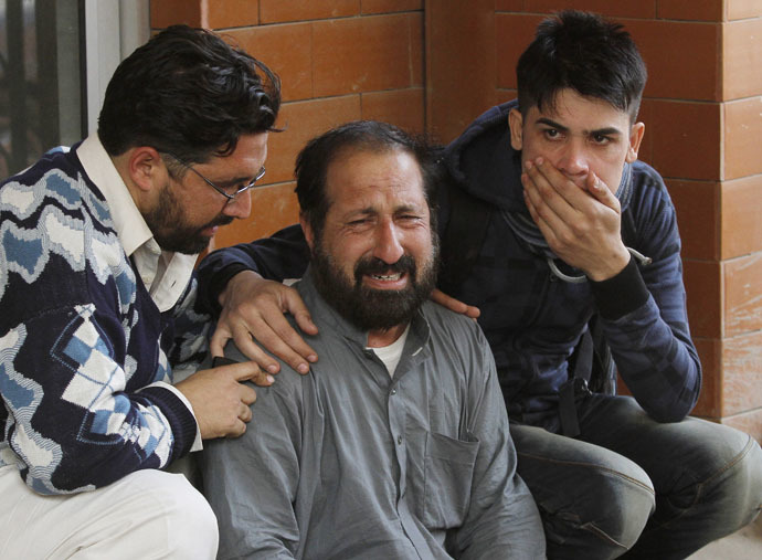 Relatives of a student, who was injured during an attack by Taliban gunmen on the Army Public School, comfort each other outside Lady Reading Hospital in Peshawar, December 16, 2014. (Reuters/Fayaz Aziz)
