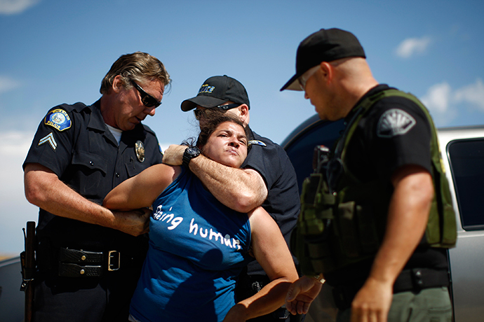 A counter-demonstrator to protesters opposing arrivals of buses carrying largely women and children undocumented migrants for processing at the Murrieta Border Patrol Station is arrested (David McNew / Getty Images / AFP) 