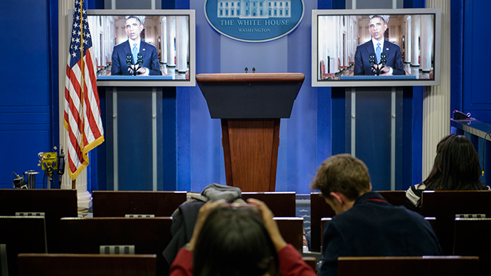 US President Barack Obama is seen on screens in the White House briefing room during a televised address to the nation November 20, 2014 in Washington, DC on immigration reform. (AFP Photo / Brendan Smialowski) 