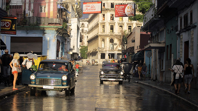 People walk as cars are driven on a street in Havana, Cuba. (Reuters/Desmond Boylan)