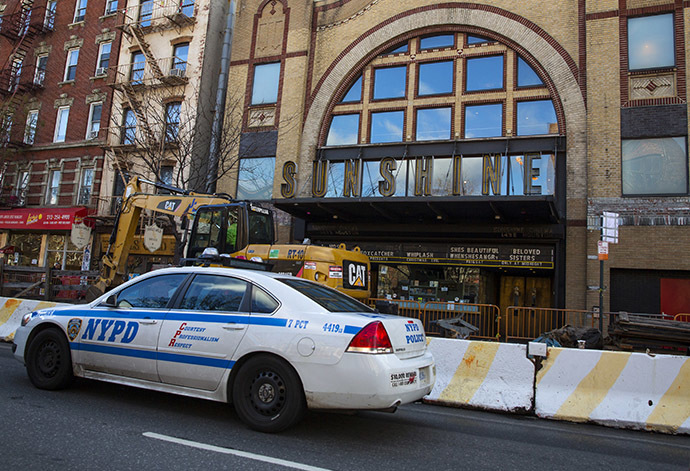 A New York City Police Department (NYPD) vehicle drives by the Sunshine Cinema in New York December 17, 2014. (Reuters/Andrew Kelly)
