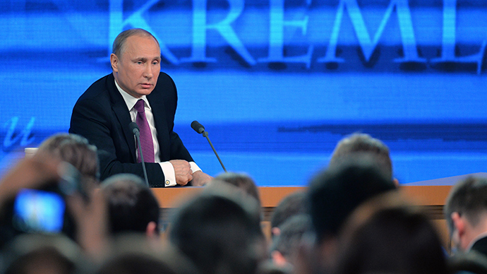 Russian President Vladimir Putin gestures as he speaks during his annual press conference in Moscow on December 18, 2014 (AFP Photo / Alexander Nemenov) 