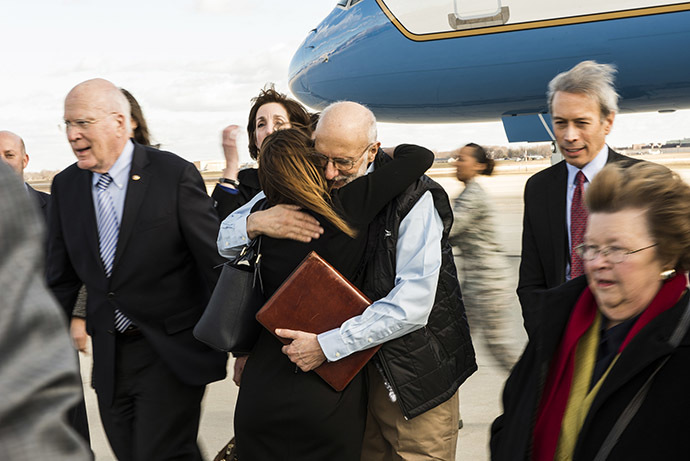 Alan Gross embraces an entourage of family and friends who were awaiting his return from five years of captivity in Cuba to Joint Base Andrews, Maryland, December 17, 2014. (Reuters/Master Sgt. Kevin Wallace/U.S. Air Force)