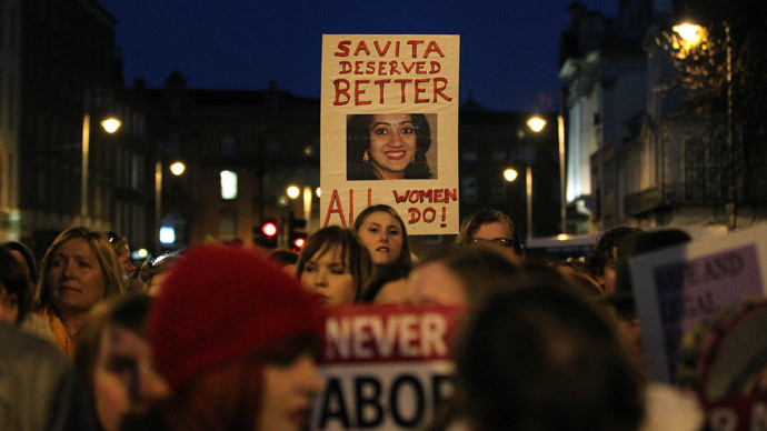Demonstrators hold placards and candels in memory of Indian Savita Halappanavar in support of legislative change on abortion during a march from the Garden of Remembrance to the Dail (Irish Parliament) in Dublin, Ireland on November 17, 2012.(AFP Photo / Peter Muhly)