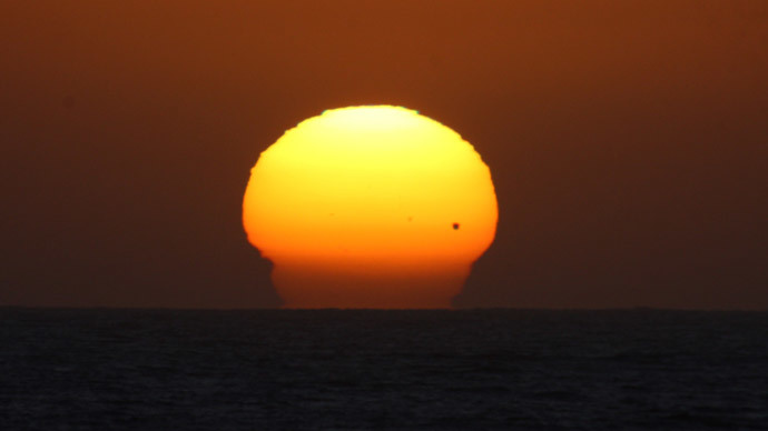 The planet Venus is seen as a black dot as it makes its transit across the sun over Tijuana.(Reuters / Jorge Duenes)