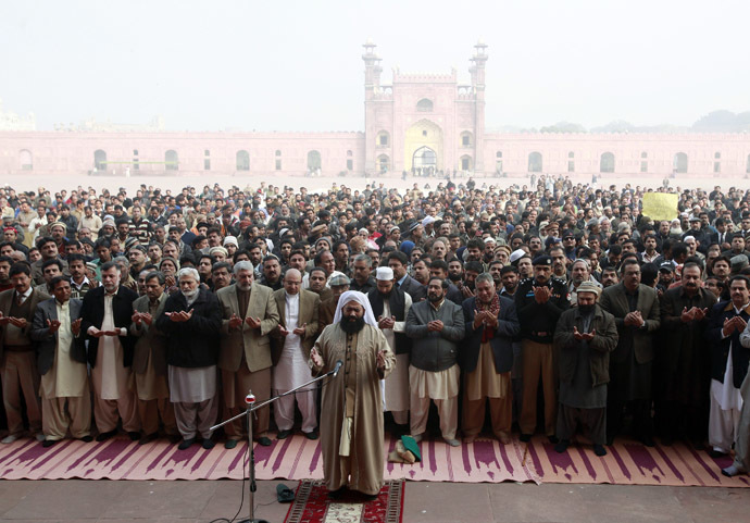People hold funeral prayers for the victims of the Taliban attack on the Army Public School in Peshawar, at the Badshahi Mosque in Lahore, December 17, 2014. (Reuters/Mohsin Raza)