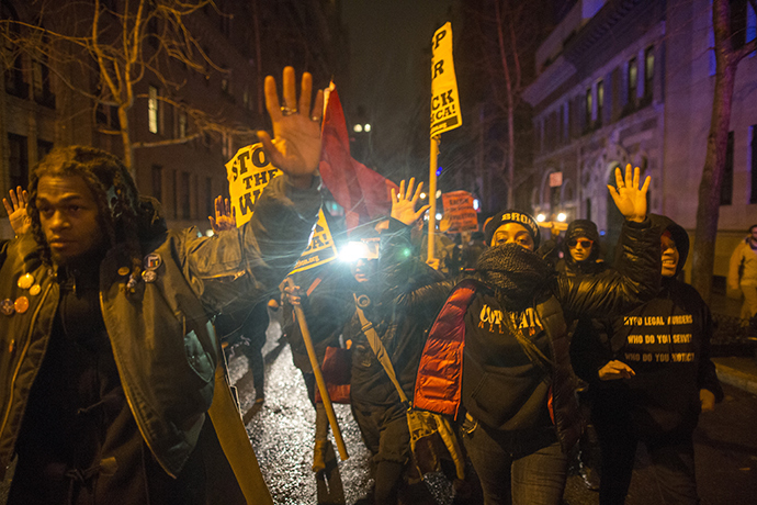 Anti-NYPD protesters march through the Upper East Side of Manhattan with their hands up in solidarity with Michael Brown on December 23, 2014 in New York City (AFP Photo / Michael Graae)