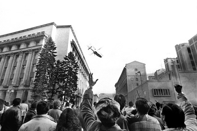 File photo of people gesturing towards a helicopter in which Ceausescu fled the Romanian Communist Party Central Committee headquarters in Bucharest December 22, 1989. (Reuters)