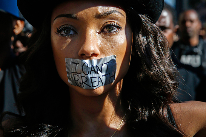 Logan Browning, with duct tape over her mouth, joins demonstrators protesting against police violence, including the July chokehold death of unarmed black man Eric Garner in New York, as they march near the area where LAPD shot an assault suspect on December 5, in Hollywood, California December 6, 2014. (Reuters / Patrick T. Fallon)