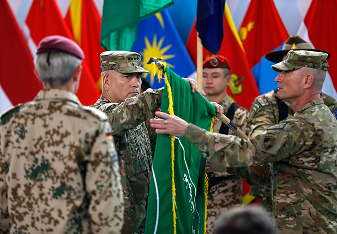 U.S. General John Campbell (C), commander of NATO-led International Security Assistance Force (ISAF), folds the flag of the ISAF during the change of mission ceremony in Kabul, December 28, 2014. (Reuters / Omar Sobhani)
