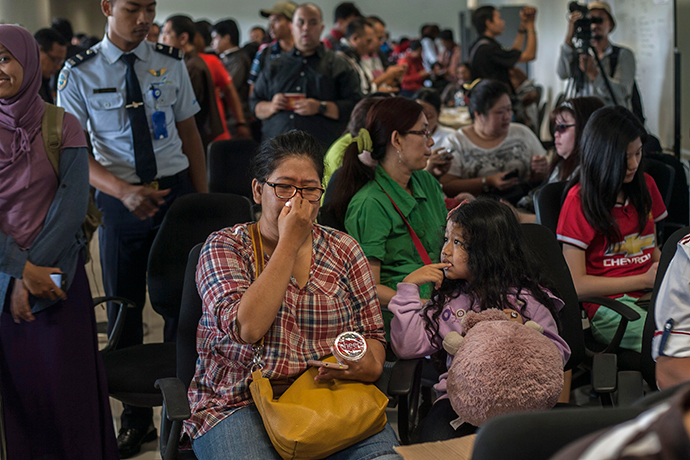 Members of passengers of missing Malaysian air carrier AirAsia flight QZ8501 gather at Juanda international airport in Surabaya in East Java on December 28, 2014 hours after the news the flight went missing. (AFP Photo / Juni Kriswanto)