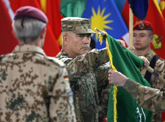 U.S. General John Campbell (C), commander of NATO-led International Security Assistance Force (ISAF), folds the flag of the ISAF during the change of mission ceremony in Kabul, December 28, 2014. (Reuters/Omar Sobhani)