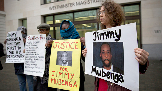 Supporters of Jimmy Mubenga hold placards outside Westminster Magistrates Court in London. (Reuters / Neil Hall)