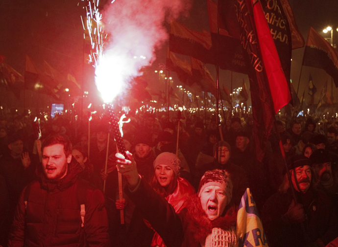 Activists of the Svoboda (Freedom) and Right Sector Ukrainian nationalist parties shout slogans as they take part in a rally to mark the 106th birth anniversary of Stepan Bandera, one of the founders of the Organization of Ukrainian Nationalists (OUN), in Kiev January 1, 2015. (Reuters / Valentyn Ogirenko)