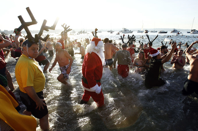 Participants run into English Bay during the 95th annual New Year's Day Polar Bear Swim in Vancouver, British Columbia January 1, 2015. (Reuters/Ben Nelms)
