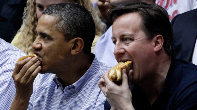U.S. President Barack Obama and British Prime Minister David Cameron each eat hot dogs at a first round "First Four" game of the NCAA Division I Men's Basketball Tournament between Mississippi Valley State and Western Kentucky at the University of Dayton Arena in Ohio, March 13, 2012 (Reuters / Larry Downing)