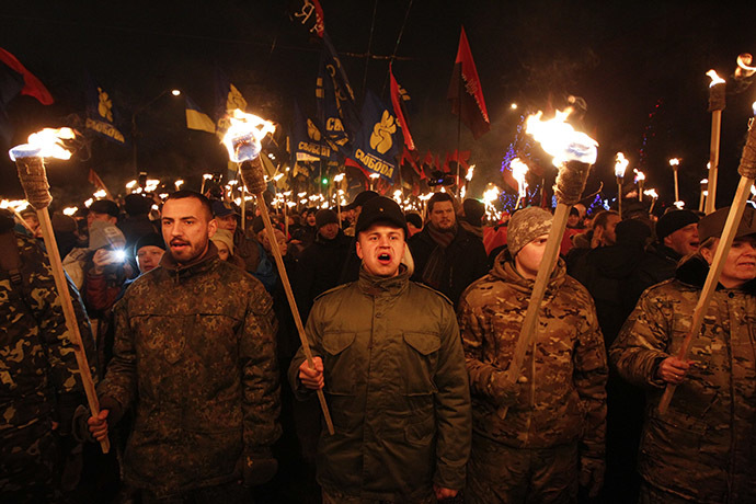 Activists of the Svoboda (Freedom) and Right Sector Ukrainian nationalist parties hold torches as they take part in a rally to mark the 106th birth anniversary of Stepan Bandera, one of the founders of the Organization of Ukrainian Nationalists (OUN), in Kiev January 1, 2015. (Reuters/Valentyn Ogirenko)