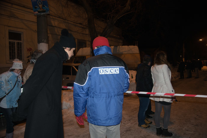 An OSCE representative seen outside the blown-up volunteer center in Odessa. (RIA Novosti/Denis Petrov)