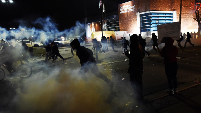 Demonstrators flee as police fire tear gas during clashes following the grand jury decision in the death of 18-year-old Michael Brown in Ferguson.(AFP Photo / Jewel Samad)