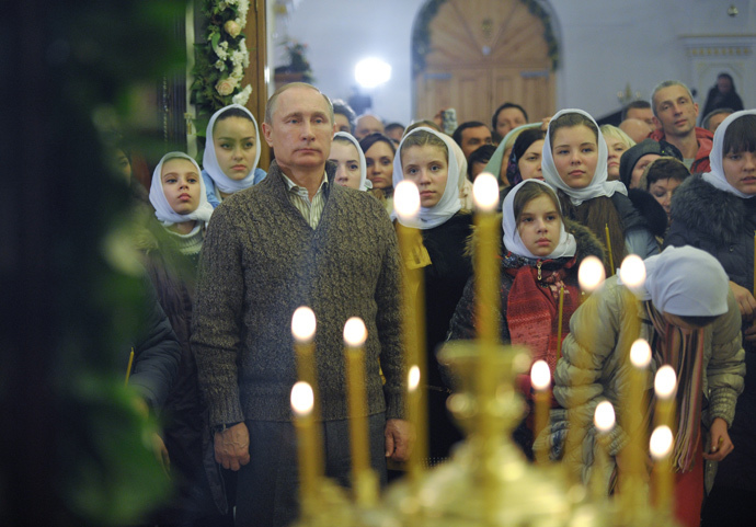 Russian President Vladimir Putin attends a Christmas Eve service at the Church of the Protection of the Blessed Virgin in the village of Otradnoye, Vornezh Region. (RIA Novosti / Alexei Druzhinin) 